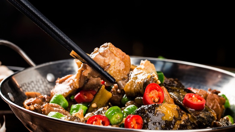A Chinese dish of turtle meat with chilies in a wok