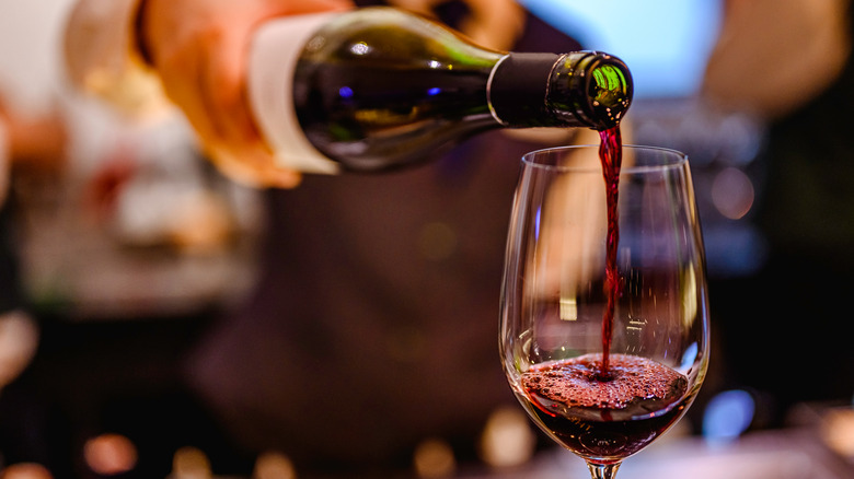 Pouring red wine from a bottle