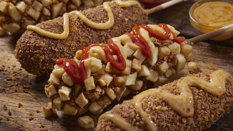 Korean corn dogs with fried potatoes and sauces