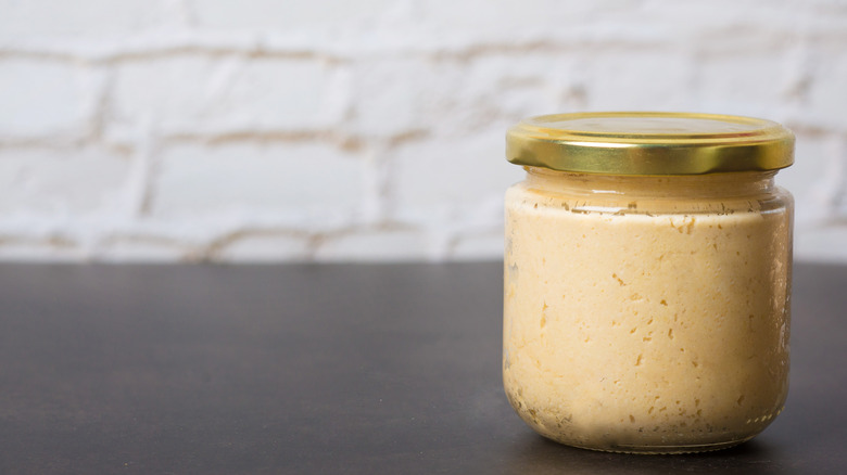 Jar of hummus and wall