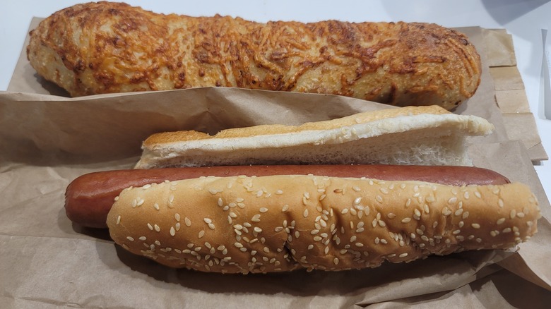 Costco hot dog laying next to Costco's chicken bake