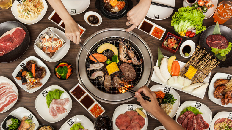 People eating around a hibachi