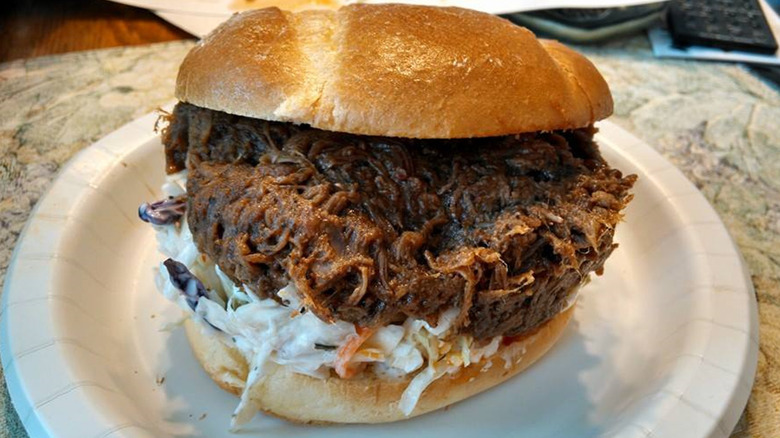 Costco barbecue brisket sandwich on a white paper plate