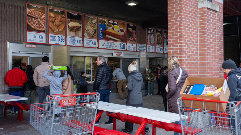 People lined up outside in front on Costco food court window