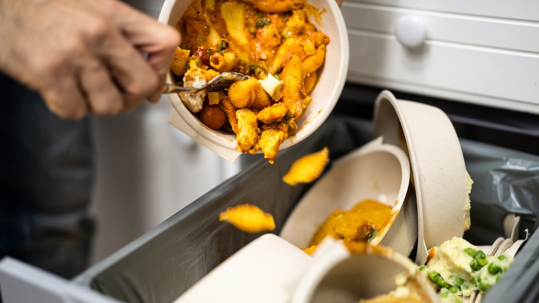 leftover food being tossed