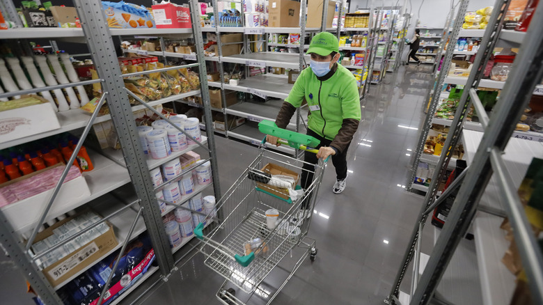 Worker in grocery store aisle