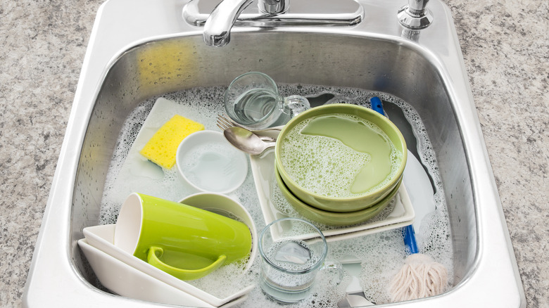 dirty dishes soaking in a sink