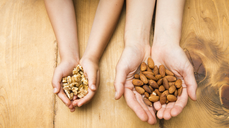 Child and parent holding nuts