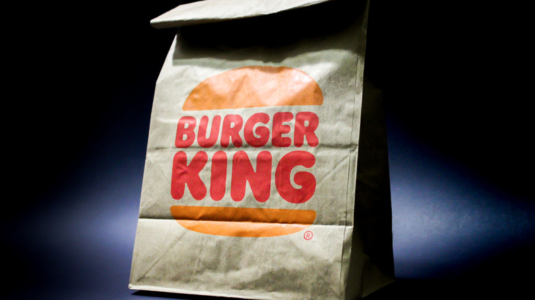 Burger King bag set against a dramatic dark background