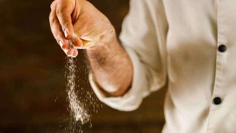 Chef sprinkling celery salt