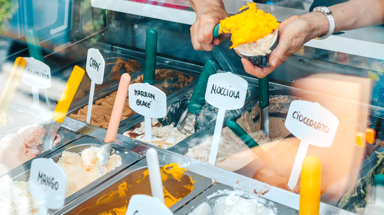 person scooping Italian gelato
