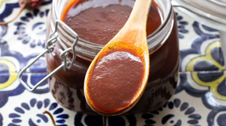 Jar and spoon of guajillo sauce