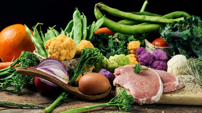 pile of fresh fruits, vegetables, and pork chops