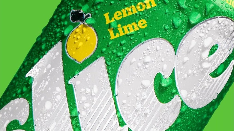 A closeup of a can of lemon-lime Slice soda, covered in condensation