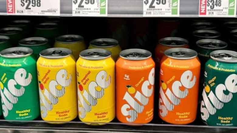 Cans of Slice on a shelf at a store