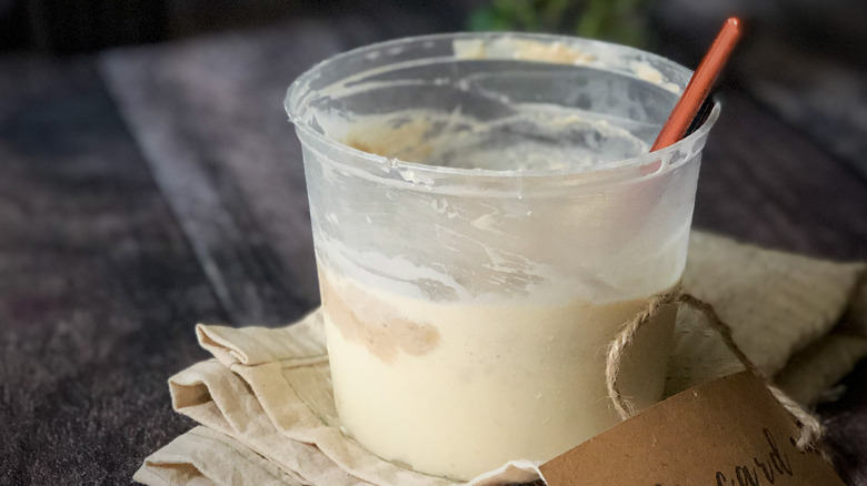 plastic container of sourdough discard