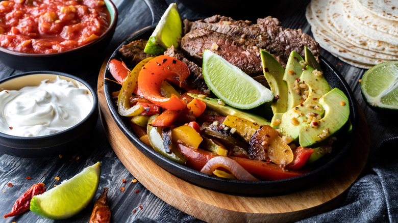 Steak fajitas, peppers, avocado, limes