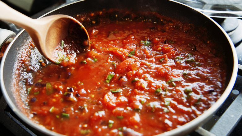 tomato sauce simmering in a pan