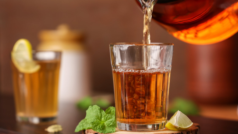Lime tea being poured into glass