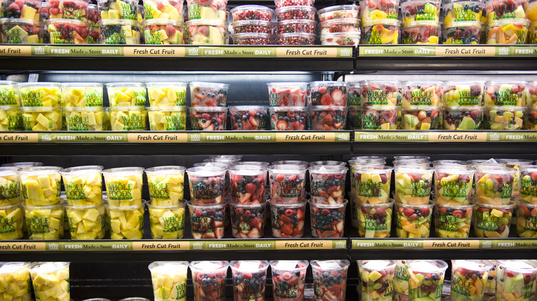fresh cut fruits in the refrigerator case at Whole Foods market