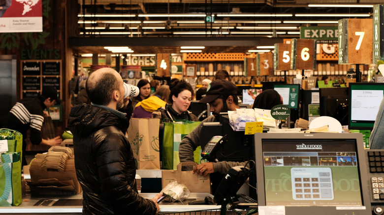Customer getting rung up by Whole Foods cashier