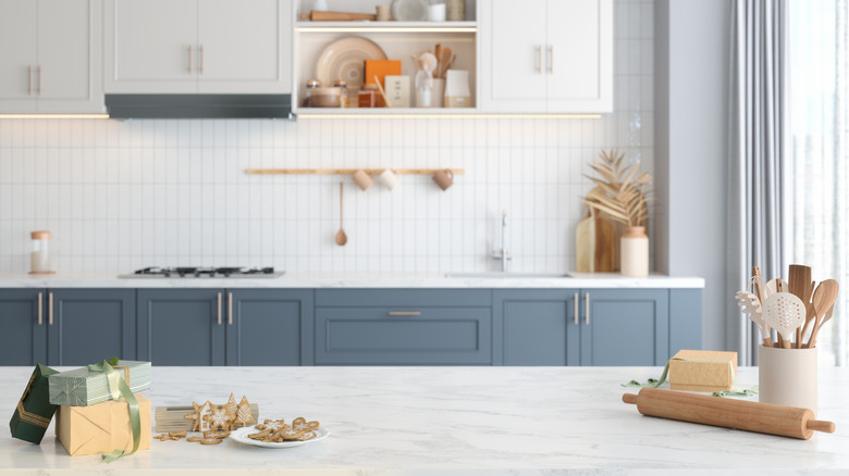 Kitchen with white and gray tones, marble, and kitchen items