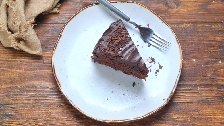Slice of chocolate cake on a wooden table