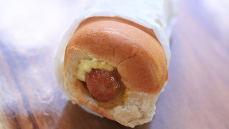 A puka dog wrapped up and ready to eat