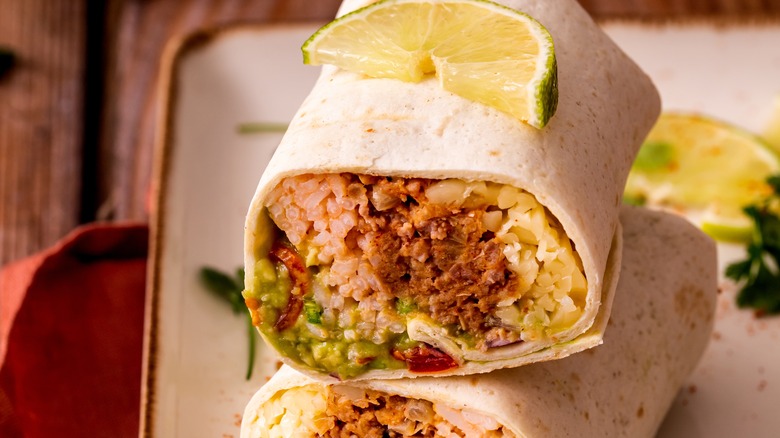 Burrito sliced in half with lime