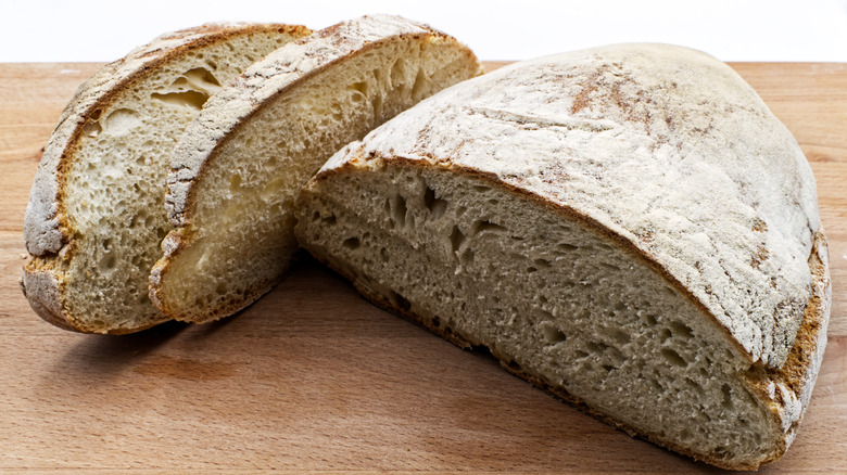 Sliced tuscan bread on wooden surface