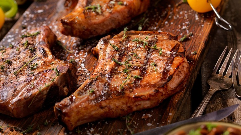 Pork chops on rustic board