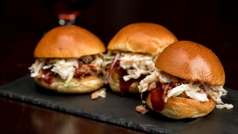 three pulled pork sliders with slaw 