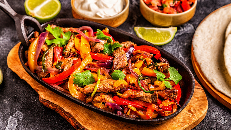 Steak fajitas in black skillet