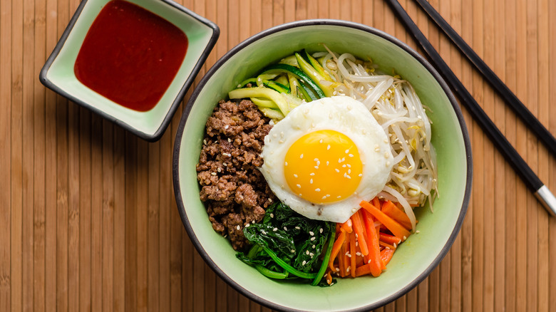 Korean bibimbap in bowl with egg