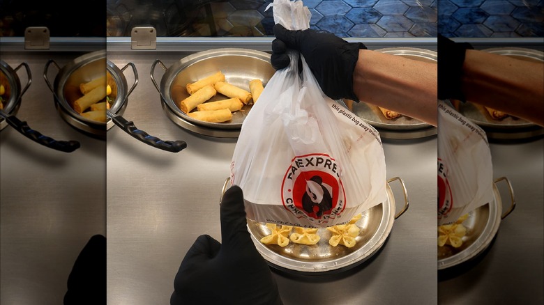 Person holding Panda Express meal with thumbs up