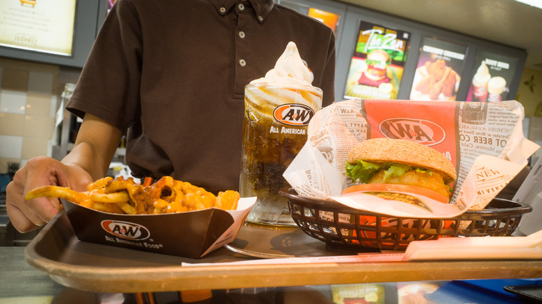 A&W employee serving food tray