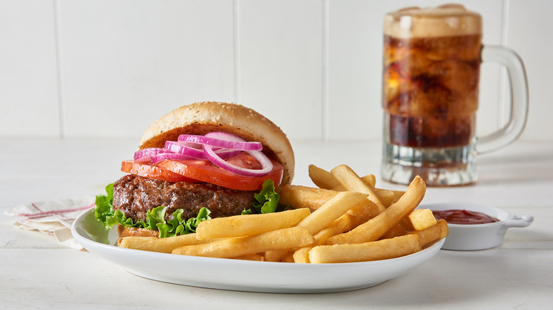 Burger fries soda on table