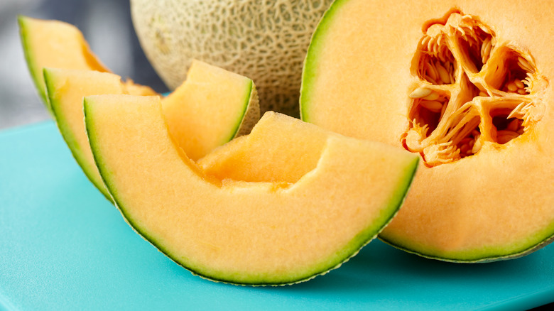 Sliced cantaloupe on blue table