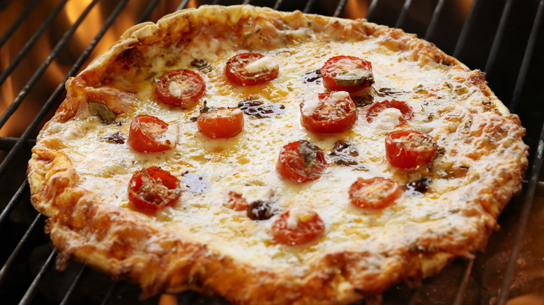 grilled pizza with tomato toppings