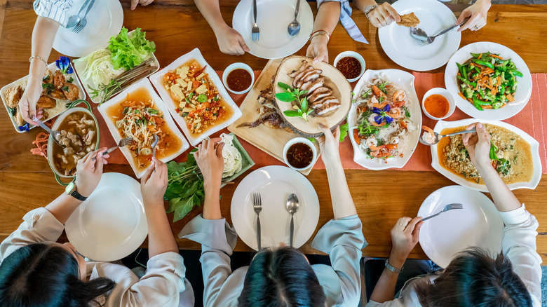 people serving food at table