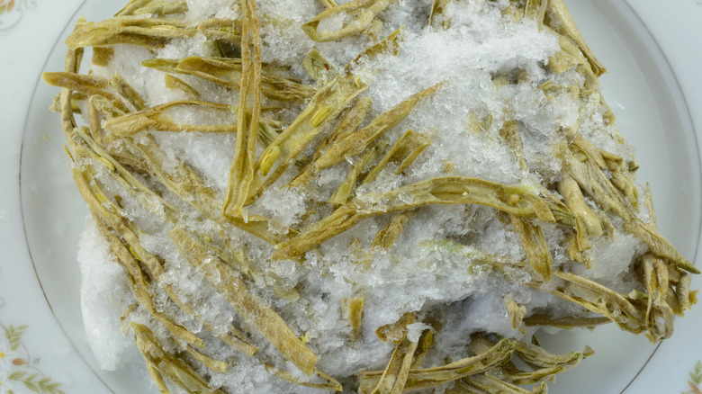 Freezer burned green beans covered in ice