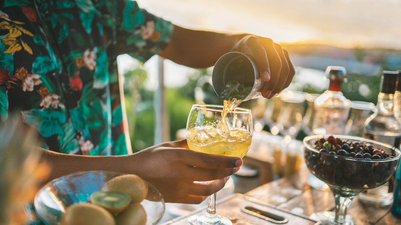 A man mixing a cocktail