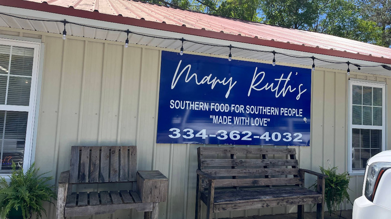 The exterior of the Mary Ruth's Restaurant, with wooden seating on the porch.