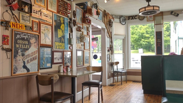 The eclectic decor inside the Ralph's Cafe dining room includes vintage posters, sports gear, and knick-knacks.