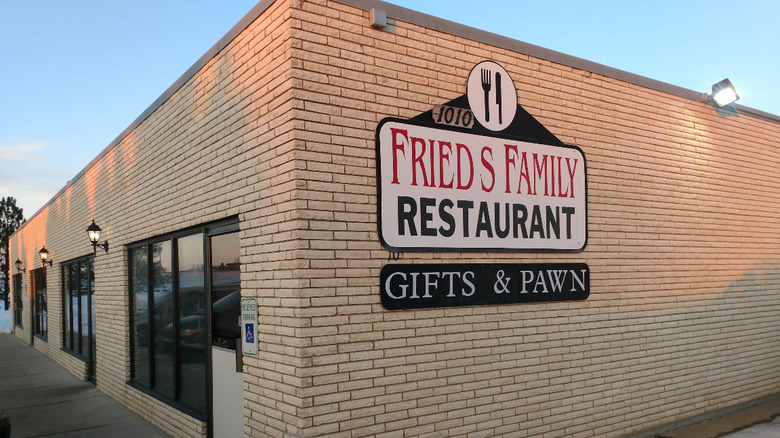 On a plain brick building hangs an old-timey looking sign for Fried's Family Restaurant in Mandan, North Dakota.