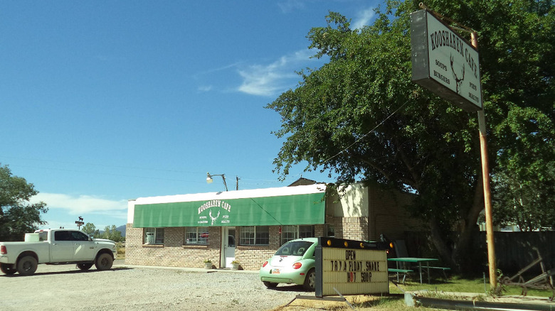 The parking lot and signage for Koosharem Cafe stands alone on a dirt road in Koosharem, Utah.