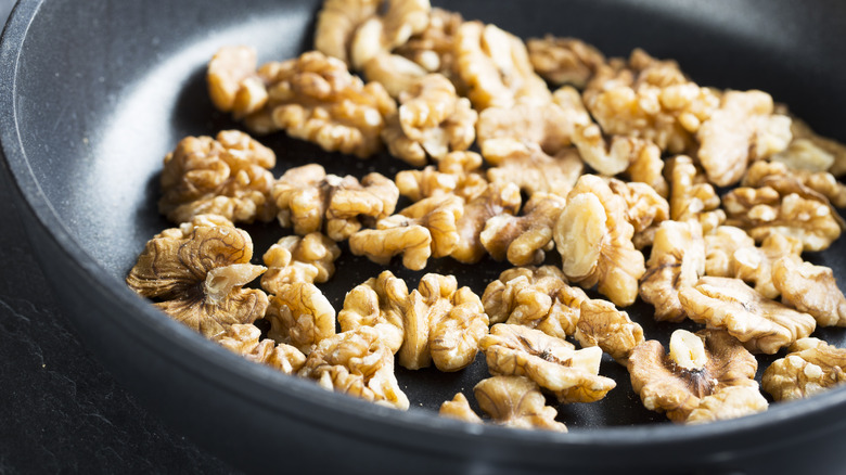 Walnuts toasting in a pan