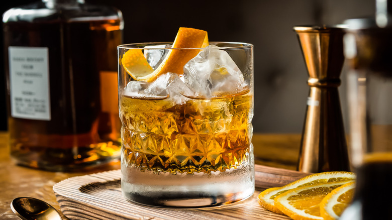 Rocks glass with liquid and orange peel