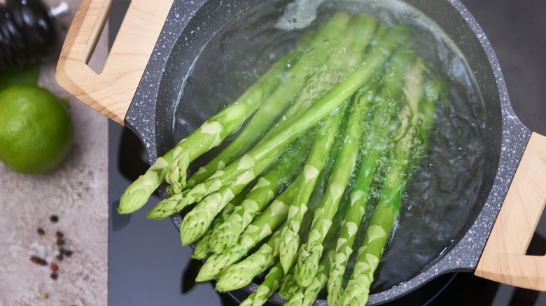 Asparagus steaming in a pot of water