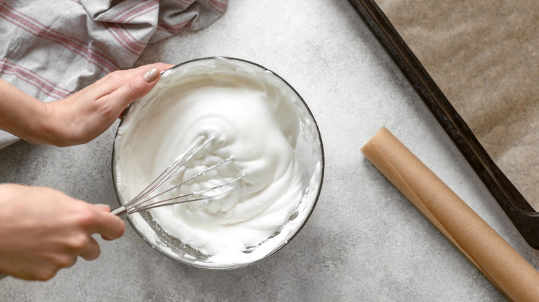 Person whipping a bowl of whipped cream